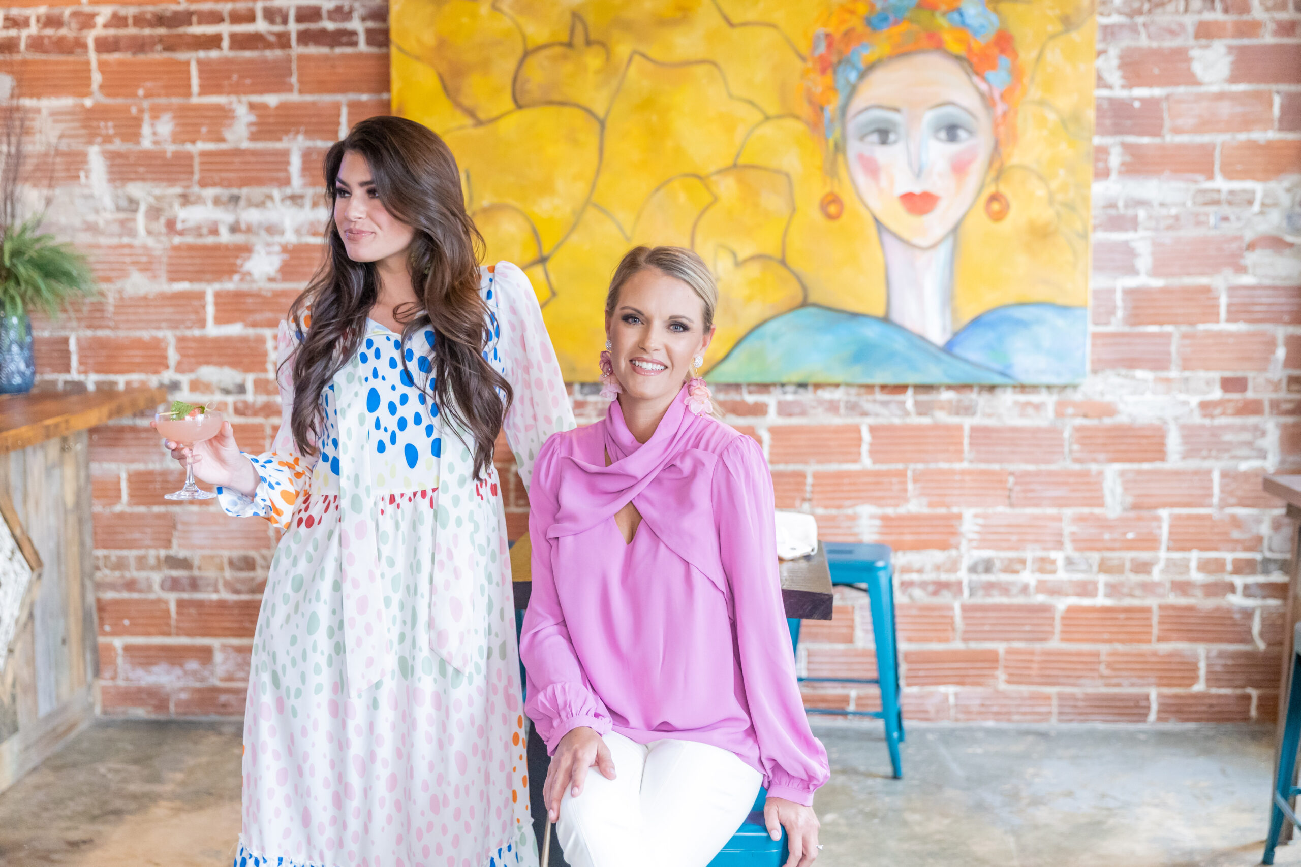 dreamy image of 2 women standing in a restaurant wearing clothes from a women's clothing boutique used to market their business and make more sales