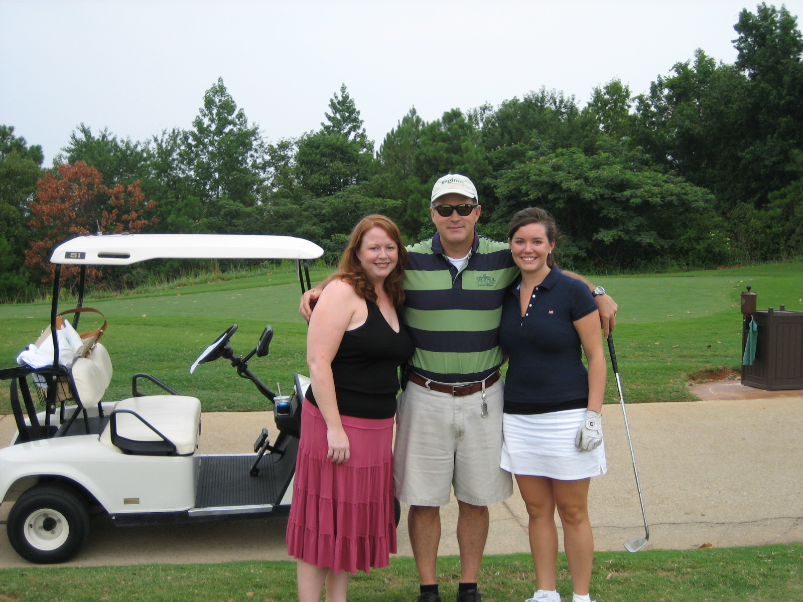 Kassady Gibson at a golf tournament while working as an auditor at Regions, smiling in a golf polo and hat, enjoying a day on the course